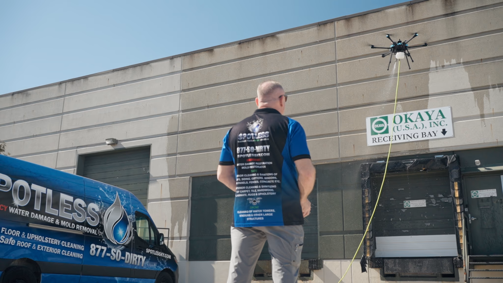 Spotless using a drone to clean the exterior of a commercial property