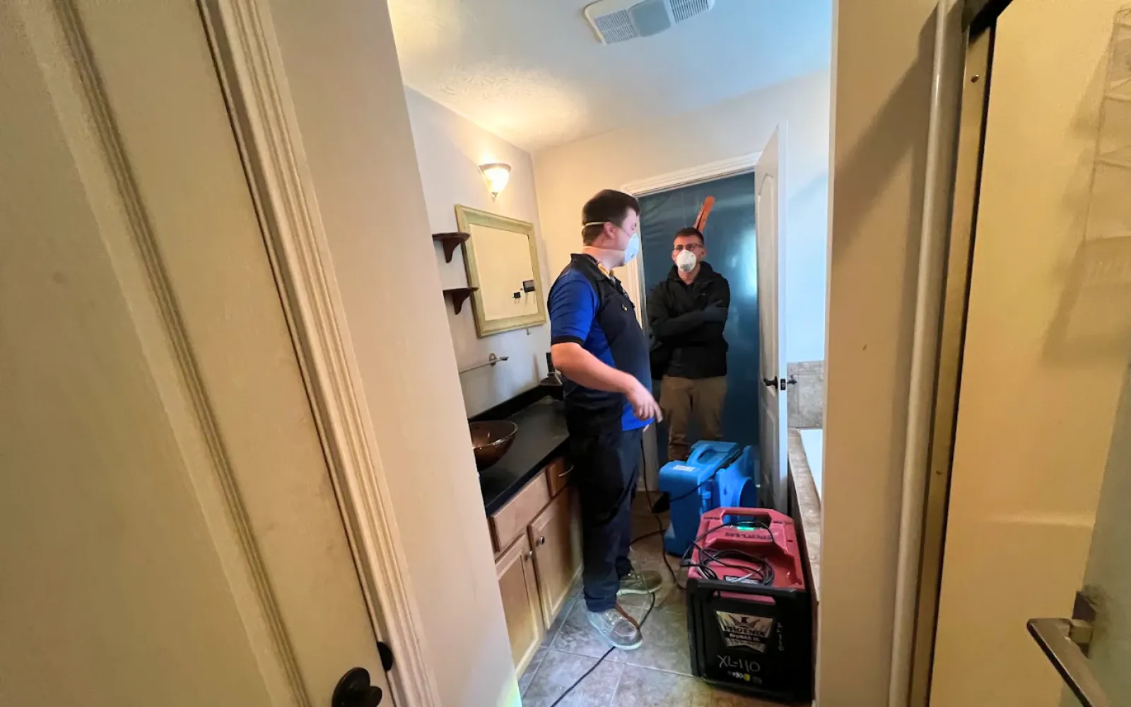 Spotless team members discussing the remediation plan for a property in Lexington KY