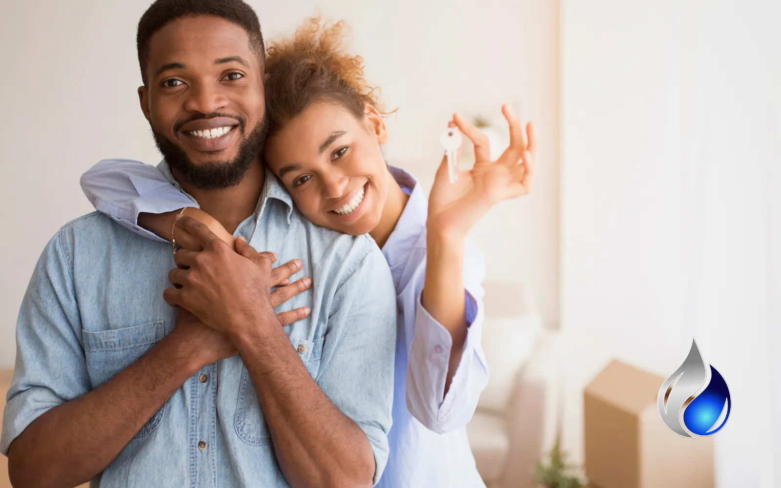 A smiling couple holding the keys to their first home, representing the importance of mold testing when buying or selling a home
