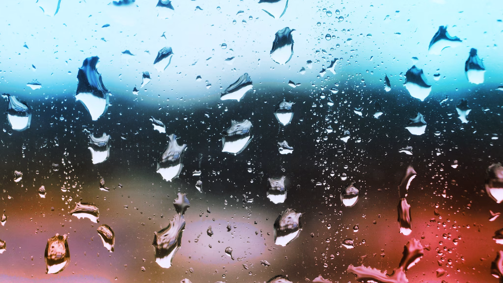 Water droplets on windows, representing how to prevent water damage during heavy rains in Kentucky homes