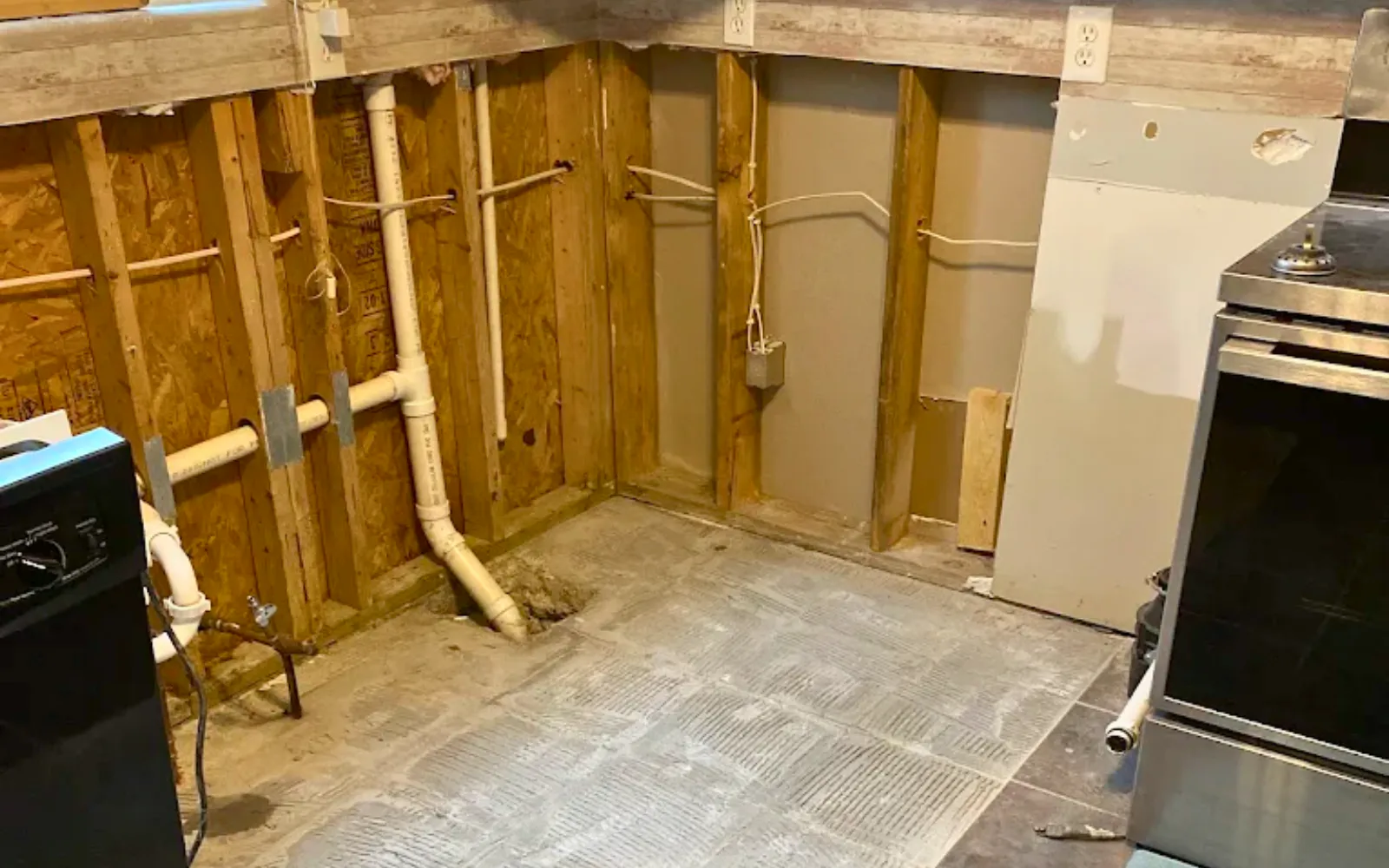 A kitchen in a Lexington home with drywall, flooring and appliances removed, representing post-remediation mold testing