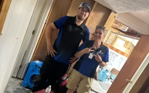 Smiling Spotless mold remediation technicians on site at a Lexington home