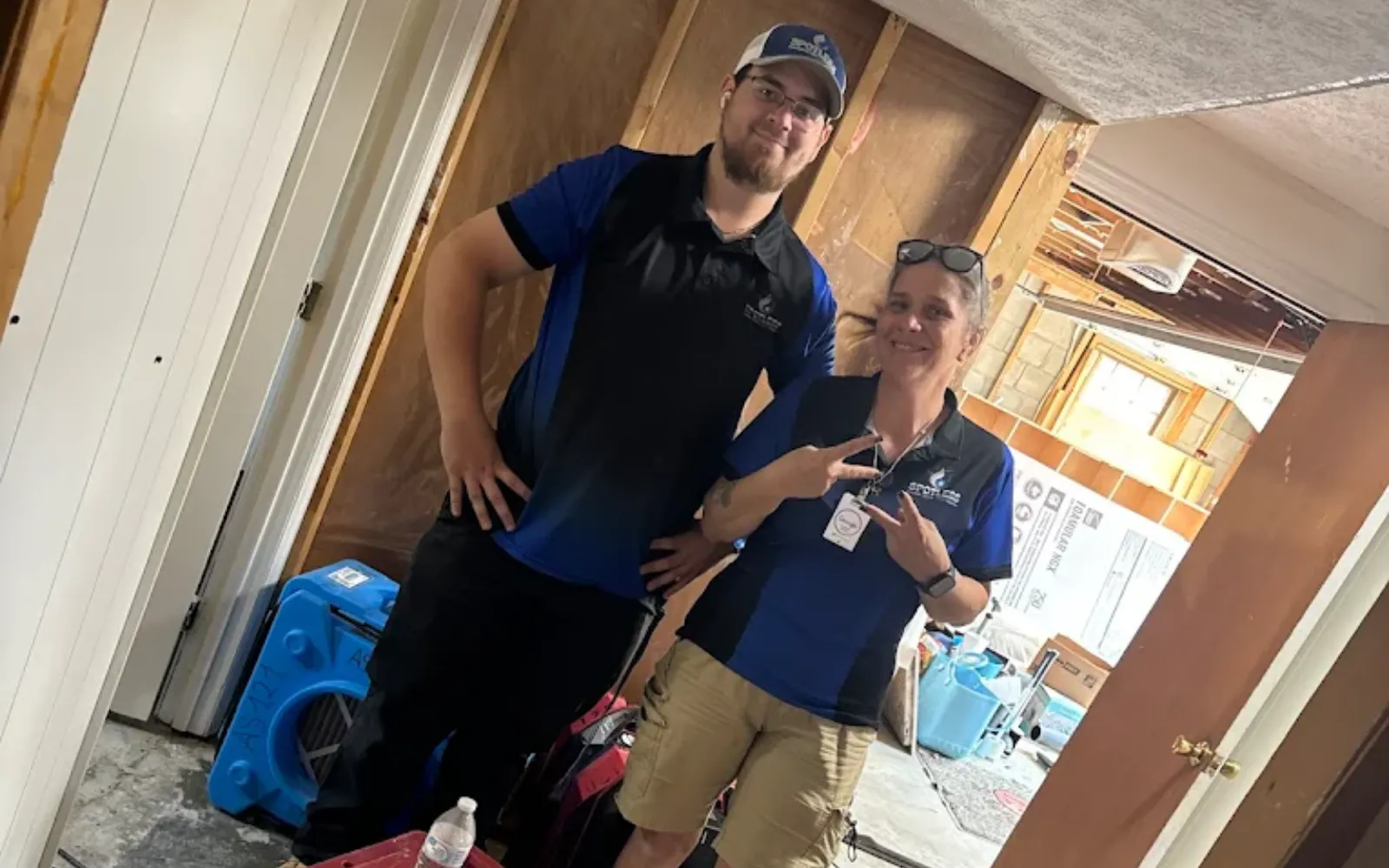 Smiling Spotless mold remediation technicians on site at a Lexington home