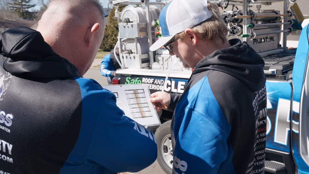 Spotless team members discussing remediation plan outside a home